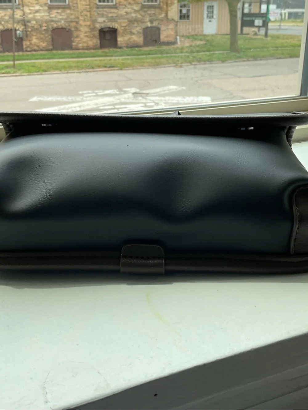 Black Crossbody Bag with Brown Trim and Adjustable Strap